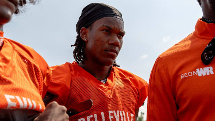 Senior Elijah Dotson, 17, listens to a coach's advice during a team practice at Belleville High School football field in Belleville on Wednesday, Aug. 14, 2024. Senior Elijah Dotson, 17, listens to a coach's advice during a team practice at Belleville High School football field in Belleville on Wednesday, Aug. 14, 2024.