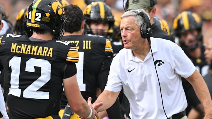 Sep 14, 2024; Iowa City, Iowa, USA; Iowa Hawkeyes head coach Kirk Ferentz reacts with quarterback Cade McNamara (12) after a touchdown against the Troy Trojans during the second quarter at Kinnick Stadium. Mandatory Credit: Jeffrey Becker-Imagn Images