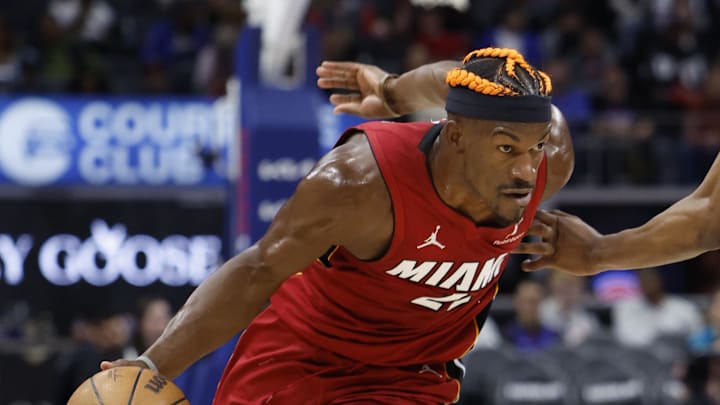 Dec 16, 2024; Detroit, Michigan, USA;  Miami Heat forward Jimmy Butler (22) dribbles around Detroit Pistons forward Ronald Holland II (00) in the first half at Little Caesars Arena. Mandatory Credit: Rick Osentoski-Imagn Images
