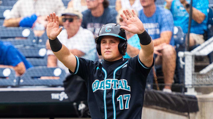 Jun 18, 2025; Omaha, Neb, USA; Coastal Carolina Chanticleers catcher Caden Bodine (17) signals to left fielder Sebastian Alexander (1) as he scores against the Louisville Cardinals during the first inning at Charles Schwab Field. Jun 18, 2025; Omaha, Neb, USA; Coastal Carolina Chanticleers catcher Caden Bodine (17) signals to left fielder Sebastian Alexander (1) as he scores against the Louisville Cardinals during the first inning at Charles Schwab Field.