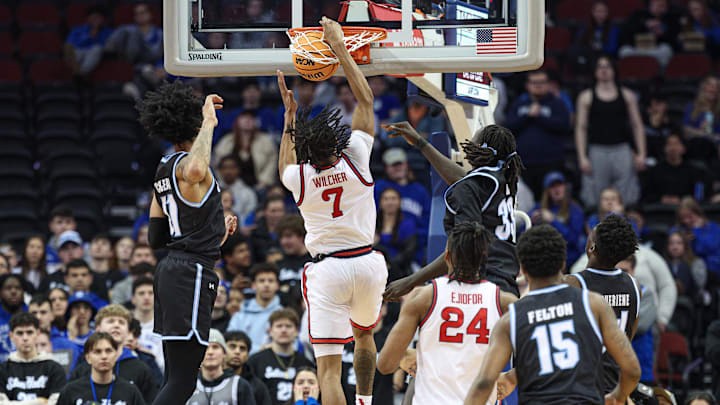 Jan 18, 2025; Newark, New Jersey, USA; St. John's basketball guard Simeon Wilcher (7) dunks the ball in front of Seton Hall Pirates guard Garwey Dual (33) during the second half at Prudential Center. 
