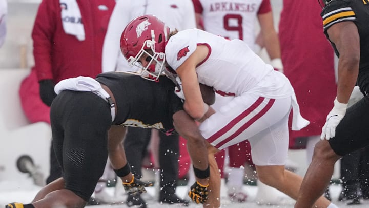 Arkansas Razorbacks wide receiver Isaac TeSlaa (4) runs the ball as Missouri Tigers safety Daylan Carnell (13) makes the tackle 