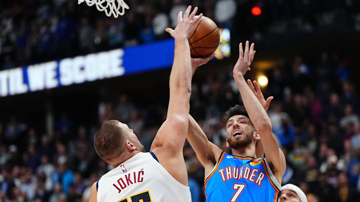 Oct 24, 2024; Denver, Colorado, USA; Denver Nuggets center Nikola Jokic (15) defends on Oklahoma City Thunder forward Chet Holmgren (7) in the first quarter at Ball Arena. Mandatory Credit: Ron Chenoy-Imagn Images