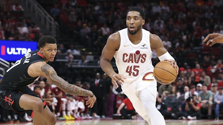 Dec 27, 2025; Houston, Texas, USA;  Cleveland Cavaliers guard Donovan Mitchell (45) drives with the ball as Houston Rockets forward Jabari Smith Jr. (10) defends during the first quarter at Toyota Center. Mandatory Credit: Troy Taormina-Imagn Images
