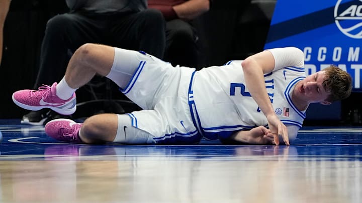 Duke forward Cooper Flagg lays on the ground after spraining his ankle.