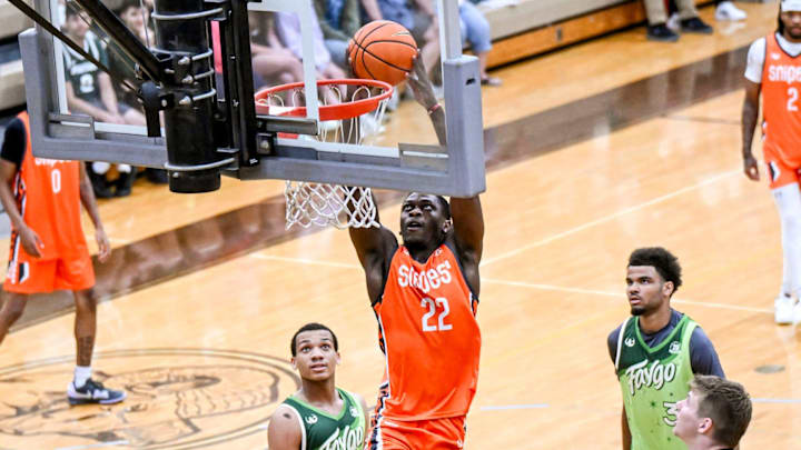 Team Snipes and Michigan State's Trey Fort dunks against Team Faygo during the Moneyball Pro-Am on Thursday, June 26, 2025, at Holt High School.