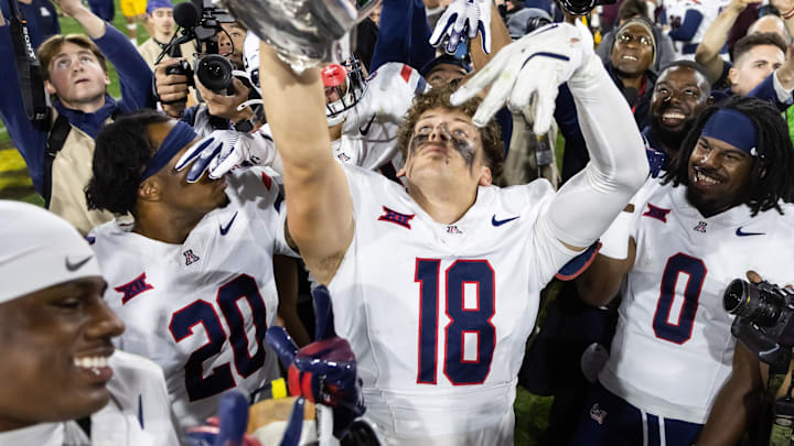 Nov 28, 2025; Tempe, Arizona, USA; Arizona Wildcats wide receiver Brandon Phelps (18) celebrates with the Territorial Cup trophy after defeating the Arizona State Sun Devils in the 99th Territorial Cup at Mountain America Stadium. Mandatory Credit: Mark J. Rebilas-Imagn Images Nov 28, 2025; Tempe, Arizona, USA; Arizona Wildcats wide receiver Brandon Phelps (18) celebrates with the Territorial Cup trophy after defeating the Arizona State Sun Devils in the 99th Territorial Cup at Mountain America Stadium. Mandatory Credit: Mark J. Rebilas-Imagn Images