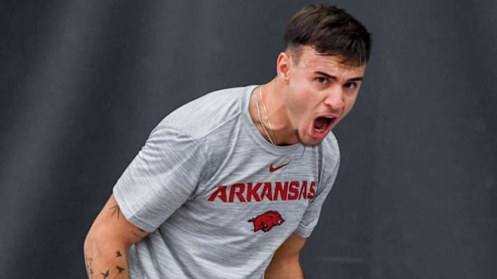 Arkansas Razorbacks tennis player reacting during match.