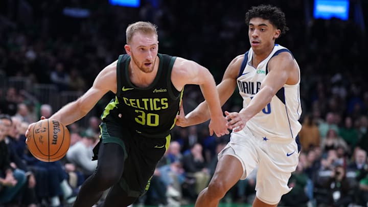 Feb 6, 2025; Boston, Massachusetts, USA; Boston Celtics forward Sam Hauser (30) drives the ball against Dallas Mavericks guard Max Christie (00) in the second half at TD Garden. Mandatory Credit: David Butler II-Imagn Images