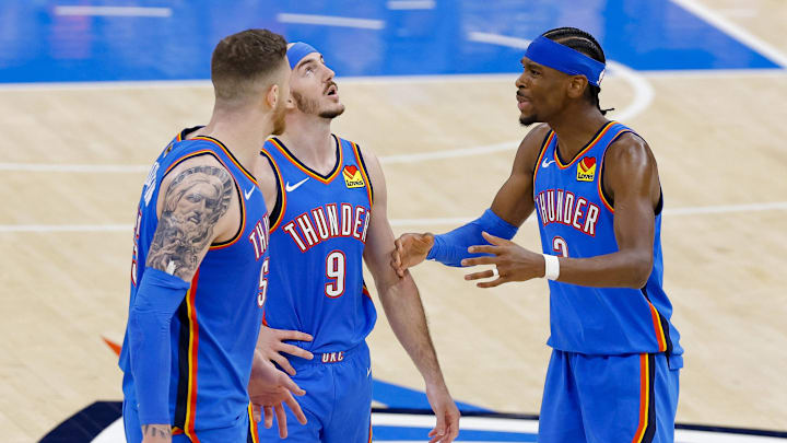 Jun 8, 2025; Oklahoma City, Oklahoma, USA; Oklahoma City Thunder center Isaiah Hartenstein (55) and guard Alex Caruso (9) and guard Shai Gilgeous-Alexander (2) talk during the third quarter against the Indiana Pacers in game two of the 2025 NBA Finals at Paycom Center. Mandatory Credit: Alonzo Adams-Imagn Images Jun 8, 2025; Oklahoma City, Oklahoma, USA; Oklahoma City Thunder center Isaiah Hartenstein (55) and guard Alex Caruso (9) and guard Shai Gilgeous-Alexander (2) talk during the third quarter against the Indiana Pacers in game two of the 2025 NBA Finals at Paycom Center. Mandatory Credit: Alonzo Adams-Imagn Images