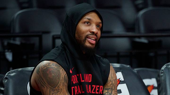 Nov 3, 2025; Portland, Oregon, USA; Portland Trail Blazers guard Damian Lillard (0) watches teammates warm up before a game against the Los Angeles Lakers at Moda Center. Mandatory Credit: Troy Wayrynen-Imagn Images Nov 3, 2025; Portland, Oregon, USA; Portland Trail Blazers guard Damian Lillard (0) watches teammates warm up before a game against the Los Angeles Lakers at Moda Center. Mandatory Credit: Troy Wayrynen-Imagn Images