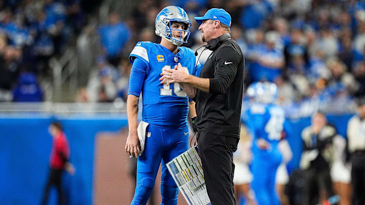 Detroit Lions quarterback Jared Goff (16) talks to head coach Dan Campbell
