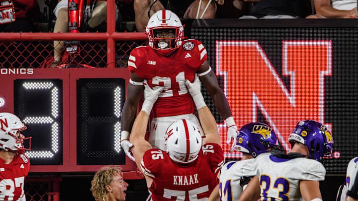 Tyler Knaak lifts Emmett Johnson after his 36-yard touchdown run. Tyler Knaak lifts Emmett Johnson after his 36-yard touchdown run.