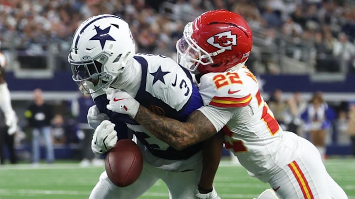 Nov 27, 2025; Arlington, Texas, USA; Kansas City Chiefs cornerback Trent McDuffie (22) forces a fumble from Dallas Cowboys wide receiver George Pickens (3) during the fourth quarter at AT&T Stadium. Mandatory Credit: Kevin Jairaj-Imagn Images