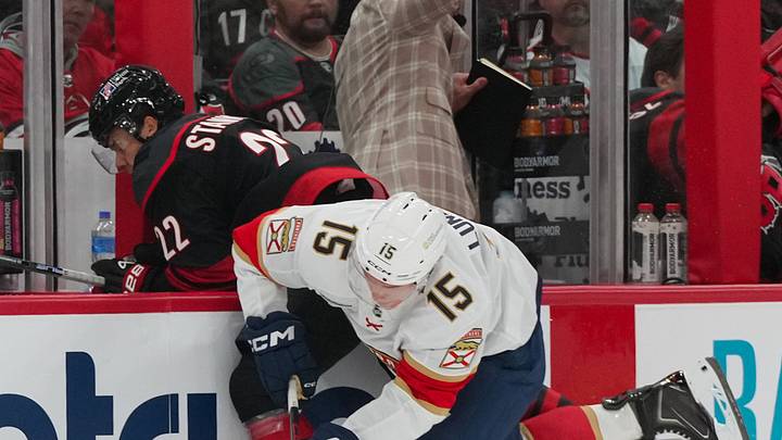 Sep 29, 2026; Raleigh, North Carolina, USA;  Florida Panthers center Anton Lundell (15) checks Carolina Hurricanes center Logan Stankoven (22) during the first period at Lenovo Center.  Mandatory Credit: James Guillory-Imagn Images