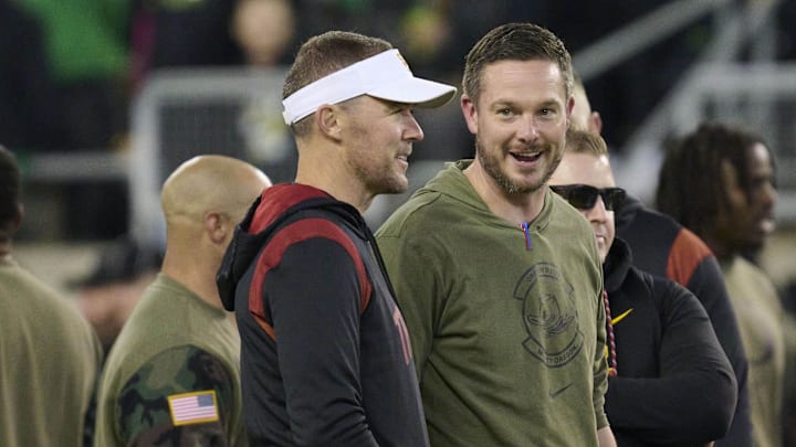 Nov 11, 2023; Eugene, Oregon, USA; USC Trojans head coach Lincoln Riley, left, and Oregon Ducks head coach Dan Lanning talk before a game at Autzen Stadium. 