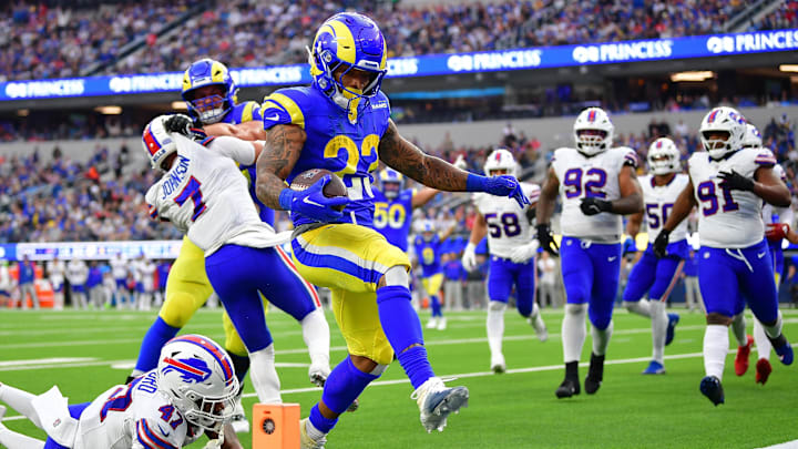 Dec 8, 2024; Inglewood, California, USA; Los Angeles Rams running back Kyren Williams (23) scores a touchdown ahead of Buffalo Bills cornerback Christian Benford (47) during the second half at SoFi Stadium. Mandatory Credit: Gary A. Vasquez-Imagn Images