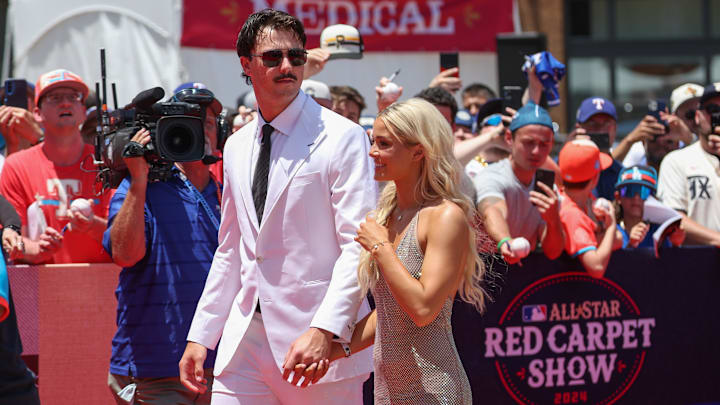 Jul 16, 2024; Arlington, Texas, USA; Pittsburgh Pirates pitcher Paul Skenes walks the red carpet with LSU gymnast and girlfriend Livvy Dunne before the 2024 MLB All-Star game at Globe Life Field. 