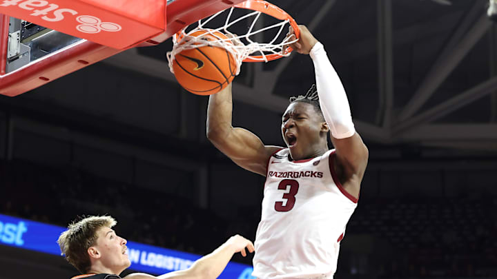 Arkansas Razorbacks forward Adou Thiero (3) aggressively dunks against Pacific Tigers forward Elias Ralph (2) during second-half action last Monday at Bud Walton Arena. Arkansas won 91-72 as Thiero led the Hogs with 23 points and eight rebounds.