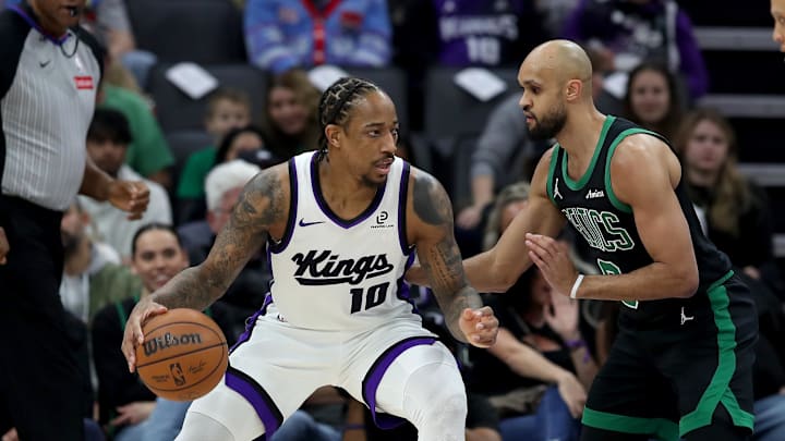 Jan 1, 2026; Sacramento, California, USA; Sacramento Kings forward DeMar DeRozan (10) controls the ball while being defended by Boston Celtics guard Derrick White (9) during the first quarter at Golden 1 Center. Mandatory Credit: Dennis Lee-Imagn Images