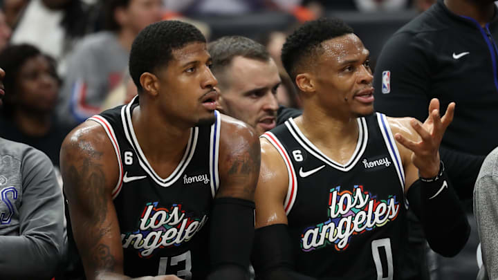 Mar 11, 2023; Los Angeles, California, USA; Los Angeles Clippers forward Paul George (13) and guard Russell Westbrook (0) watch the game against the New York Knicks from the bench at Crypto.com Arena. Mandatory Credit: Kiyoshi Mio-Imagn Images