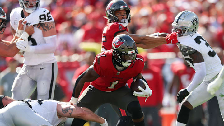 Dec 8, 2024; Tampa, Florida, USA; Tampa Bay Buccaneers running back Rachaad White (1) runs with the ball against the Las Vegas Raiders in the first quarter at Raymond James Stadium. Mandatory Credit: Nathan Ray Seebeck-Imagn Images