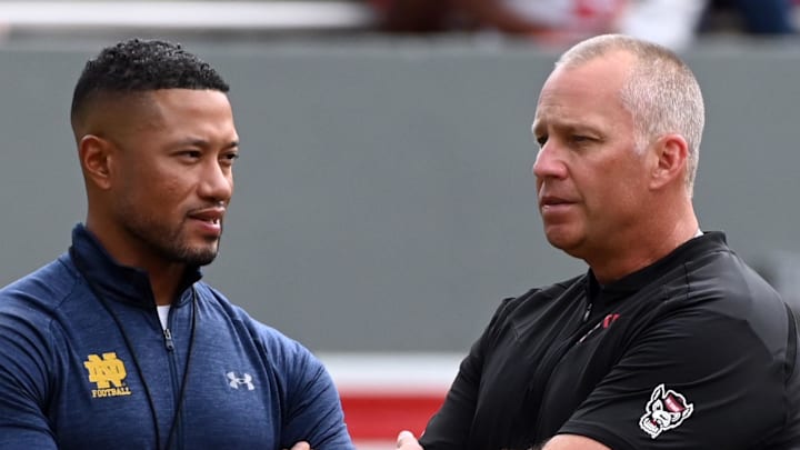 Sep 9, 2023; Raleigh, North Carolina, USA; Notre Dame Fighting Irish head coach Marcus Freeman (left) and North Carolina State Wolfpack head coach Dave Doeren chat prior to a game at Carter-Finley Stadium. Mandatory Credit: Rob Kinnan-Imagn Images Sep 9, 2023; Raleigh, North Carolina, USA; Notre Dame Fighting Irish head coach Marcus Freeman (left) and North Carolina State Wolfpack head coach Dave Doeren chat prior to a game at Carter-Finley Stadium. Mandatory Credit: Rob Kinnan-Imagn Images