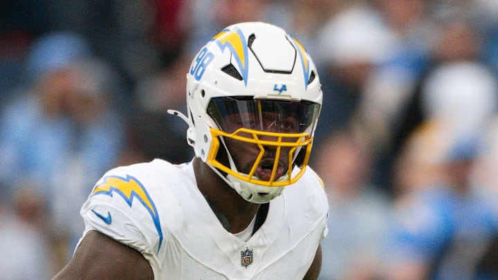 Los Angeles Chargers linebacker Odafe Oweh celebrates his sack with linebacker Tuli Tuipulotu.