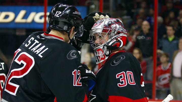 Dec 18, 2014; Raleigh, NC, USA; Carolina Hurricanes goalie Cam Ward (30) celebrates the victory with forward Eric Staal (12) against the Toronto Maple Leafs at PNC Arena. The Carolina Hurricanes defeated the Toronto Maple Leafs 4-1. Mandatory Credit: James Guillory-Imagn Images