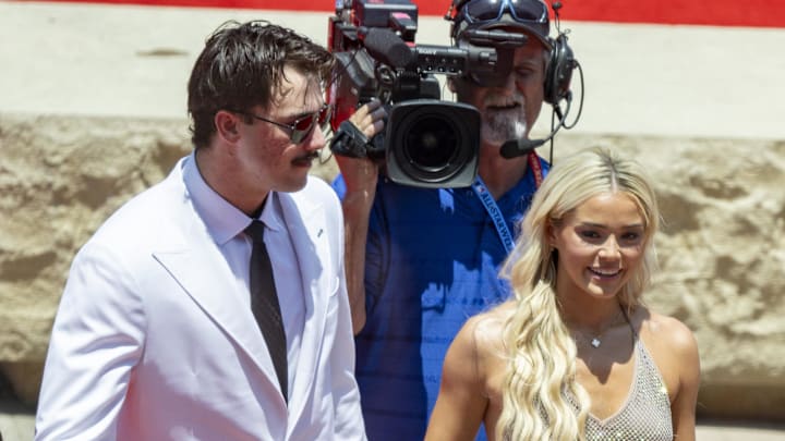 Jul 16, 2024; Arlington, Texas, USA; National League pitcher Paul Skenes of the Pittsburgh Pirates walks the red carpet with his girlfriend LSU gymnast Olivia Livvy Dunne before the 2024 MLB All-Star game at Globe Life Field.