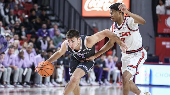 Dec 7, 2024; Queens, New York, USA;  Kansas State Wildcats guard Brendan Hausen (11) drives past St. John's Red Storm guard Simeon Wilcher (7) in the first half at Carnesecca Arena. Mandatory Credit: Wendell Cruz-Imagn Images