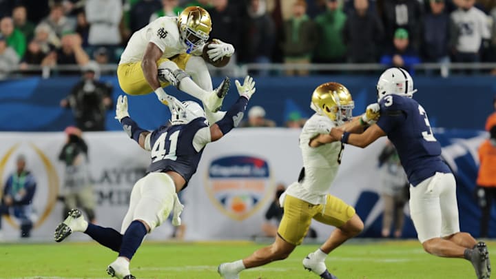 Jan 9, 2025; Miami, FL, USA; (Editors Note: Caption Correction) Notre Dame Fighting Irish running back Jeremiyah Love (4) leaps over Penn State Nittany Lions linebacker Kobe King (41) in the second half in the Orange Bowl at Hard Rock Stadium. 