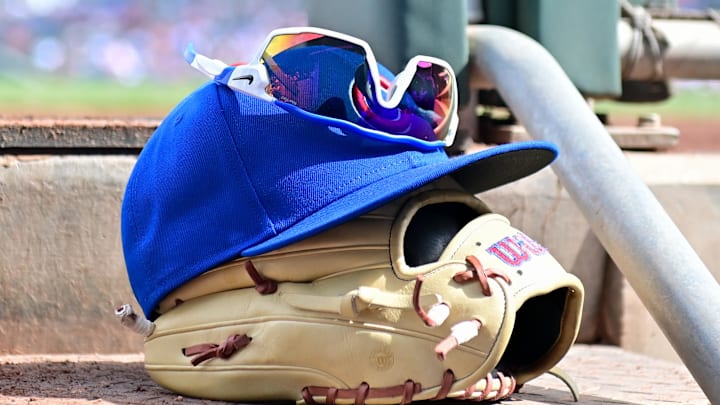 Feb 27, 2024; Mesa, Arizona, USA;  General view of a Chicago Cubs glove, hat and glasses in the first inning against the Cincinnati Reds during a spring training game at Sloan Park. 