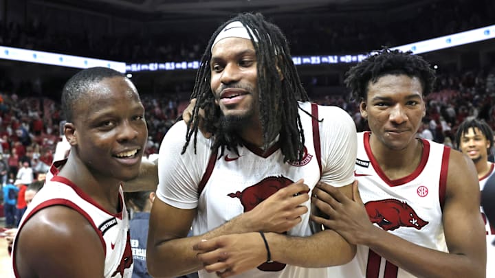 Arkansas Razorbacks guard Johnell Davis (1) celebrates with forwards Jonas Aidoo (9) and Karter Knox (11) after the game against the Mississippi State Bulldogs at Bud Walton Arena in Fayetteville, Ark.