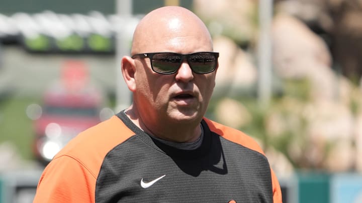Apr 24, 2022; Anaheim, California, USA; Baltimore Orioles starting pitcher Chris Ellis (39) is escorted off the field by athletic trainer Brian Ebel after being removed in the first inning against the Los Angeles Angels at Angel Stadium