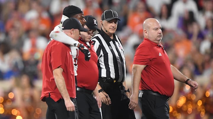 Nov 2, 2024; Clemson, South Carolina, USA; Louisville Cardinals defensive back Benjamin Perry (10) is assisted off the field by staff during first quarter against the Clemson Tigers at Memorial Stadium. 