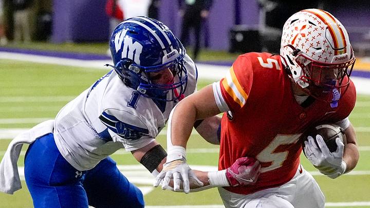 Kuemper Catholic’s Jarin Hoffman (5) carries the ball as Van Meter’s Andon Watson (1) looks to make a tackle Nov. 21, 2025 during the Class 2A high school state football championship at the UNI-Dome in Cedar Falls, Iowa. Kuemper Catholic’s Jarin Hoffman (5) carries the ball as Van Meter’s Andon Watson (1) looks to make a tackle Nov. 21, 2025 during the Class 2A high school state football championship at the UNI-Dome in Cedar Falls, Iowa.
