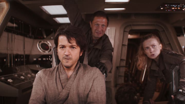 (L-R): Cassian Andor (Diego Luna), Arvel Skeen (Ebon Moss-Bachrach), Karis Nemik (Alex Lawther, seated) and Vel Sartha (Faye Marsay) in Lucasfilm's ANDOR, exclusively on Disney+. ©2022 Lucasfilm Ltd. & TM. All Rights Reserved.