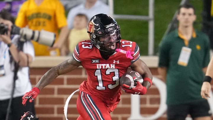 Utah Utes running back Daniel Bray (13) carries the ball against the Baylor Bears during the first half at McLane Stadium.