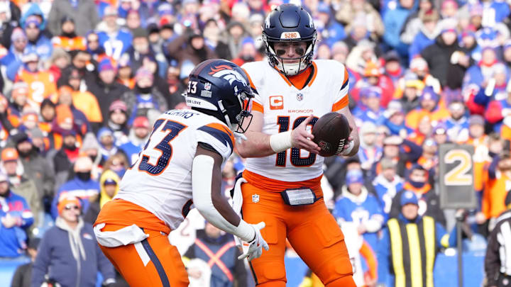 Jan 12, 2025; Orchard Park, New York, USA; Denver Broncos quarterback Bo Nix (10) hands the ball off to Denver Broncos running back Javonte Williams (33) during the third quarter against the Buffalo Bills in an AFC wild card game at Highmark Stadium. 