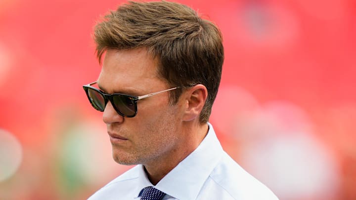 Sep 14, 2025; Kansas City, Missouri, USA; Philadelphia Eagles general manager Howie Roseman greets Fox Sports broadcaster Tom Brady prior to the game between the Kansas City Chiefs and the Philadelphia Eagles at GEHA Field at Arrowhead Stadium. Mandatory Credit: Jay Biggerstaff-Imagn Images