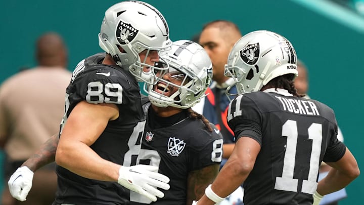 Nov 17, 2024; Miami Gardens, Florida, USA; Las Vegas Raiders tight end Brock Bowers (89) celebrates a touchdown in the third quarter with teammates running back Ameer Abdullah (8) and wide receiver Tre Tucker (11) at Hard Rock Stadium. Mandatory Credit: Jim Rassol-Imagn Images