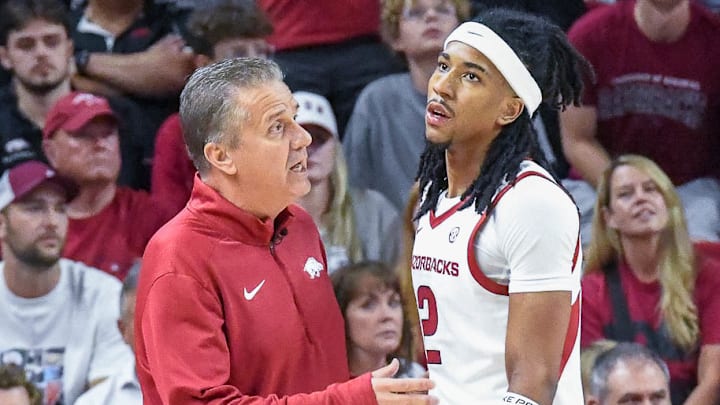 Arkansas Razorbacks coach John Calipari and point guard Boogie Fland talking on the sidelines during exhibition game with the Kansas Jayhawks at Bud Walton Arena in Fayetteville, Ark. Arkansas Razorbacks coach John Calipari and point guard Boogie Fland talking on the sidelines during exhibition game with the Kansas Jayhawks at Bud Walton Arena in Fayetteville, Ark.
