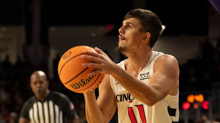 Cincinnati Bearcats guard Kerr Kriisa (11) hits a 3-point basket in the first half of the NCAA basketball game against the Lipscomb Bisons at Fifth Third Arena in Cincinnati on Dec. 29, 2025.
