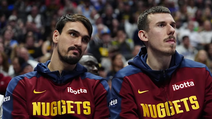 Mar 28, 2025; Denver, Colorado, USA; Denver Nuggets forward Dario Saric (9) and forward Vlatko Cancar (31) on the bench in the fourth quarter against the Utah Jazz at Ball Arena. Mandatory Credit: Ron Chenoy-Imagn Images
