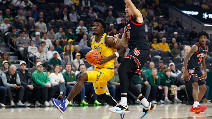 Mar 7, 2026; Waco, Texas, USA;  Baylor Bears guard Tounde Yessoufou (24) drives to the basket ahead of Utah Utes forward James Okonkwo (32) during the first half at Paul and Alejandra Foster Pavilion. Mandatory Credit: Chris Jones-Imagn Images