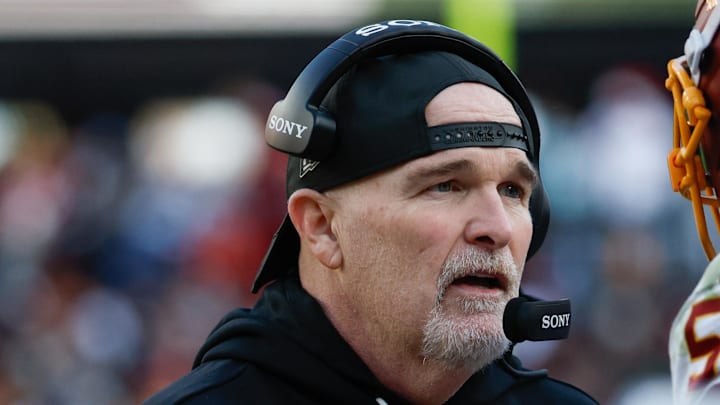 Washington Commanders head coach Dan Quinn speaks to his players in the second half against the Dallas Cowboys.