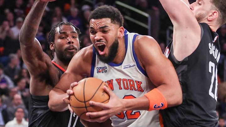 Feb 21, 2026; New York, New York, USA;  New York Knicks center Karl-Anthony Towns (32) looks to drive past Houston Rockets forward Tari Eason (17) and center Alperen Sengun (28) in the third quarter at Madison Square Garden. Mandatory Credit: Wendell Cruz-Imagn Images