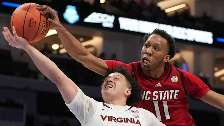 Mar 12, 2026; Charlotte, NC, USA; NC State Wolfpack guard Quadir Copeland (11) blocks Virginia Cavaliers guard Chance Mallory's (2) shot in the second half at Spectrum Center. Mandatory Credit: Bob Donnan-Imagn Images
