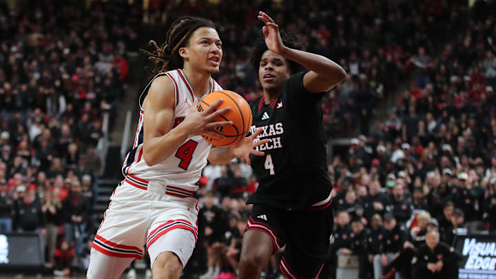 Houston Cougars guard Kingston Flemings (4) drives the lane against Texas Tech Red Raiders guard Christian Anderson (4) in the second half at United Supermarkets Arena.